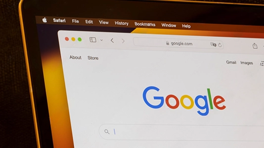Google search homepage displayed on a laptop, representing a website flagged as spam